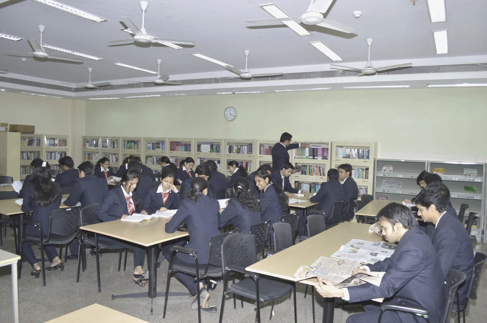 Management students reading books and newspaper in SRBS Library